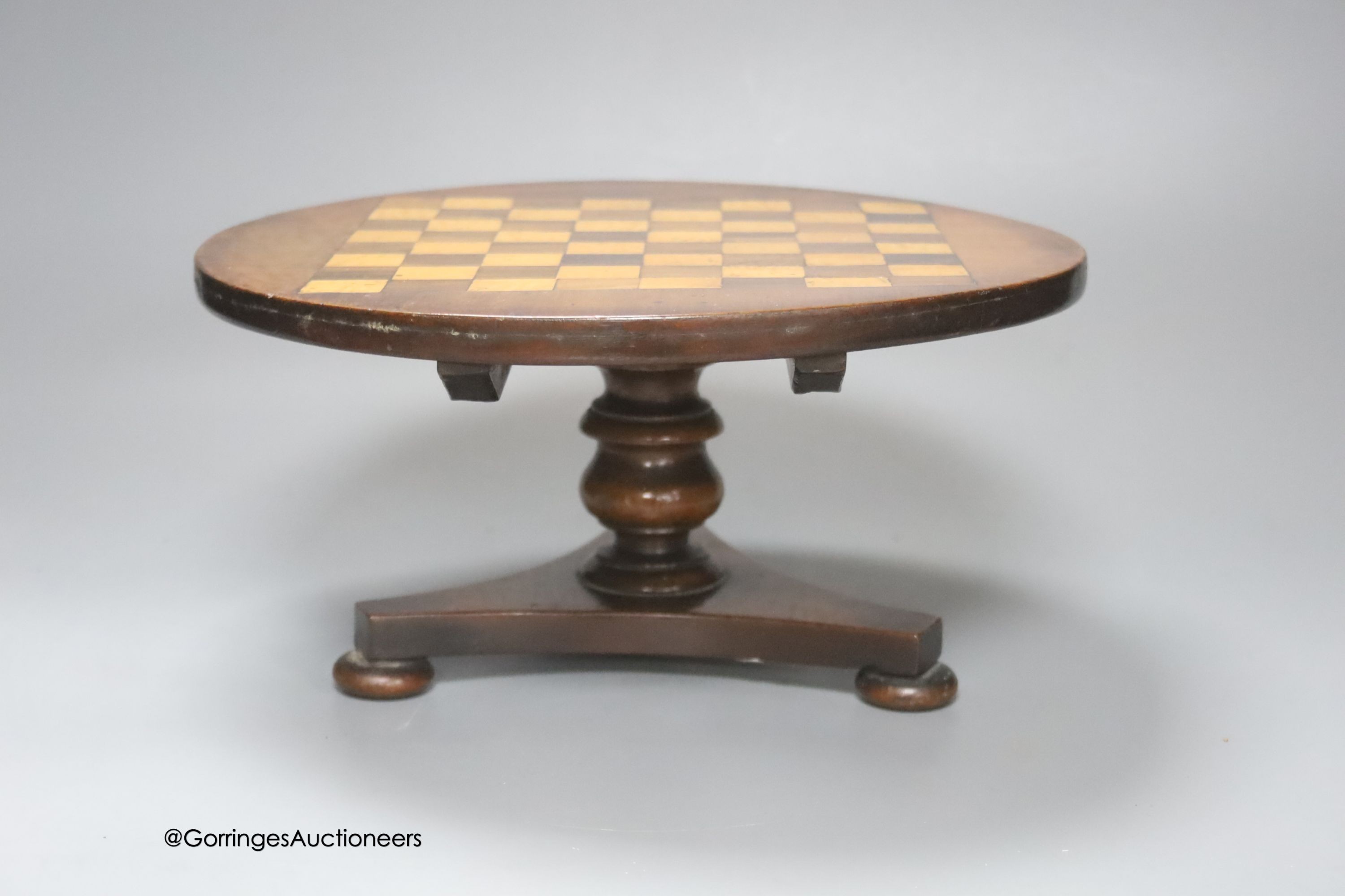 An Apprentice made miniature mahogany, rosewood and satiwnood tilt top games table, diameter 27cm